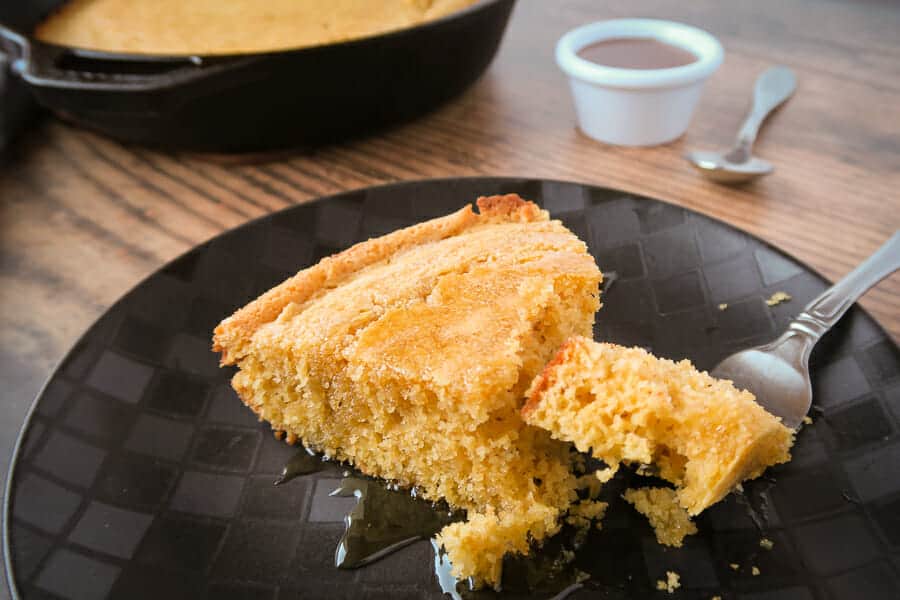 easy skillet cornbread slice drizzled with honey 